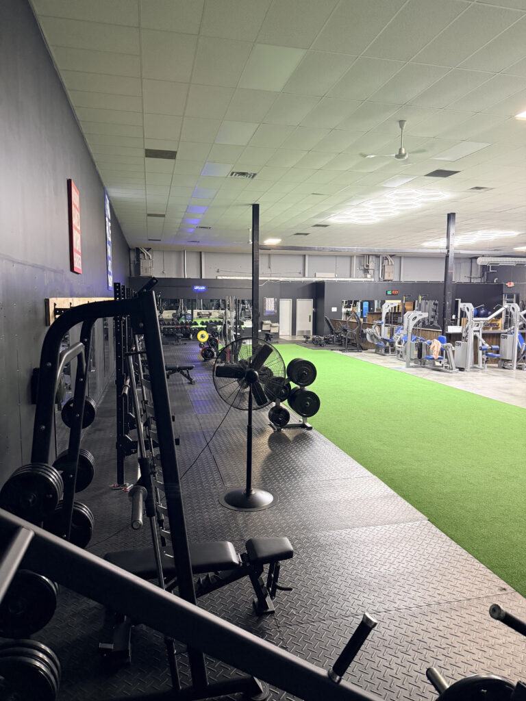 Weight training equipment beside the turf area